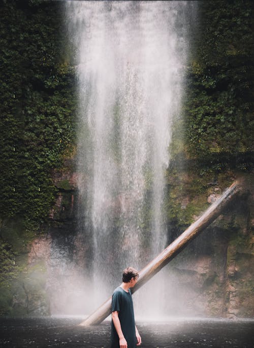 A Man Standing Beside the Waterfalls