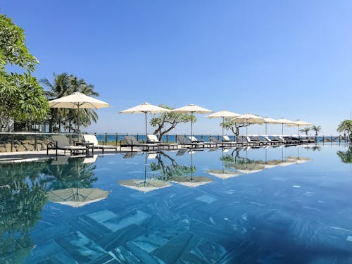 White Patio Umbrellas Near Swimming Pool