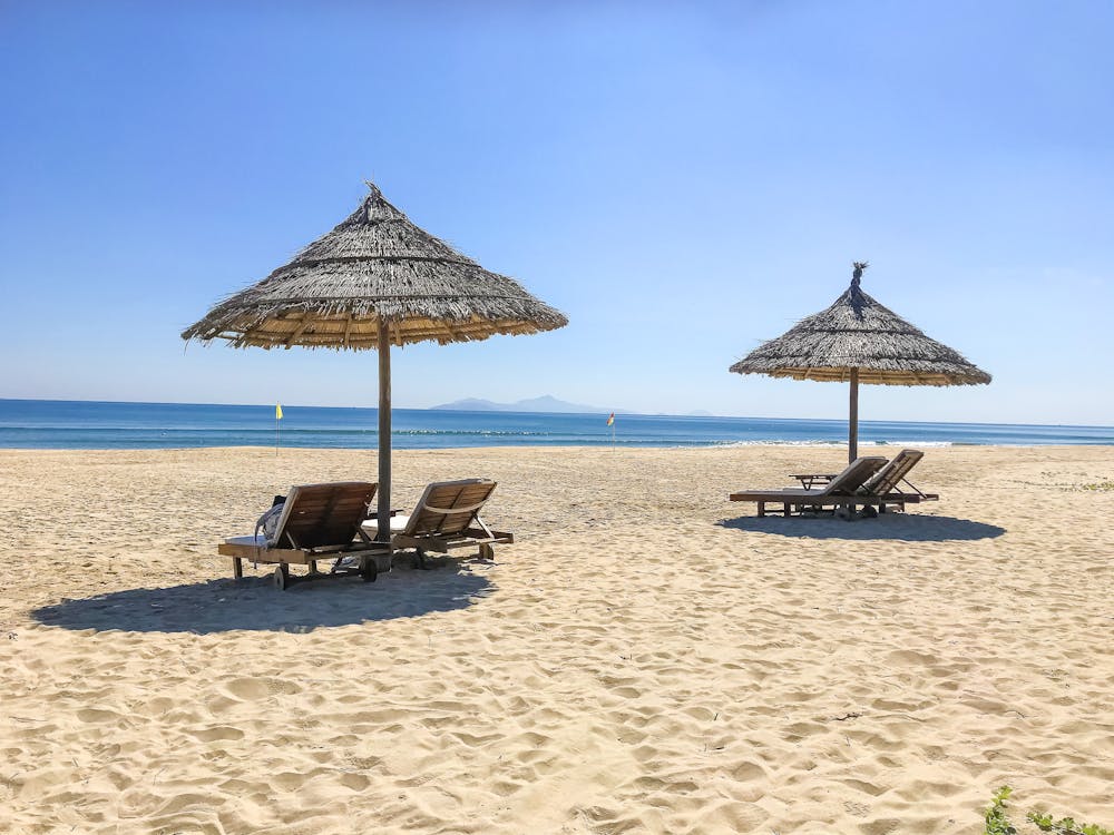 Brown Wooden Beach Lounge Chairs on Beach