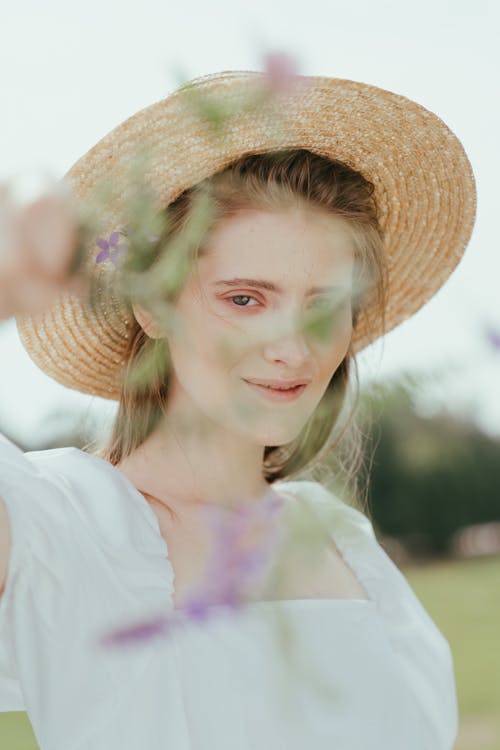 Free A Woman Wearing a Straw Hat Stock Photo