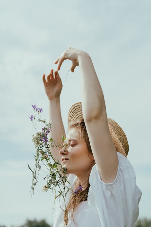 Free Woman Tossing Bunch of Flowers Stock Photo