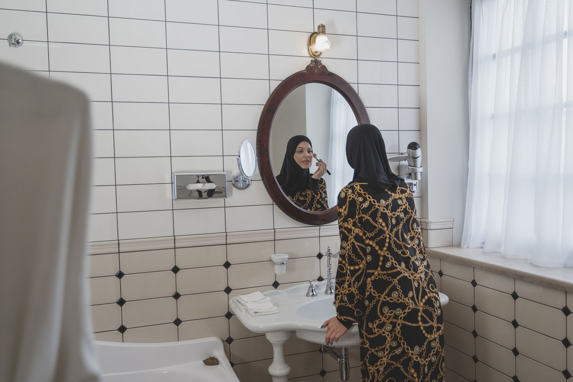 woman applying moisturiser bathroom mirror