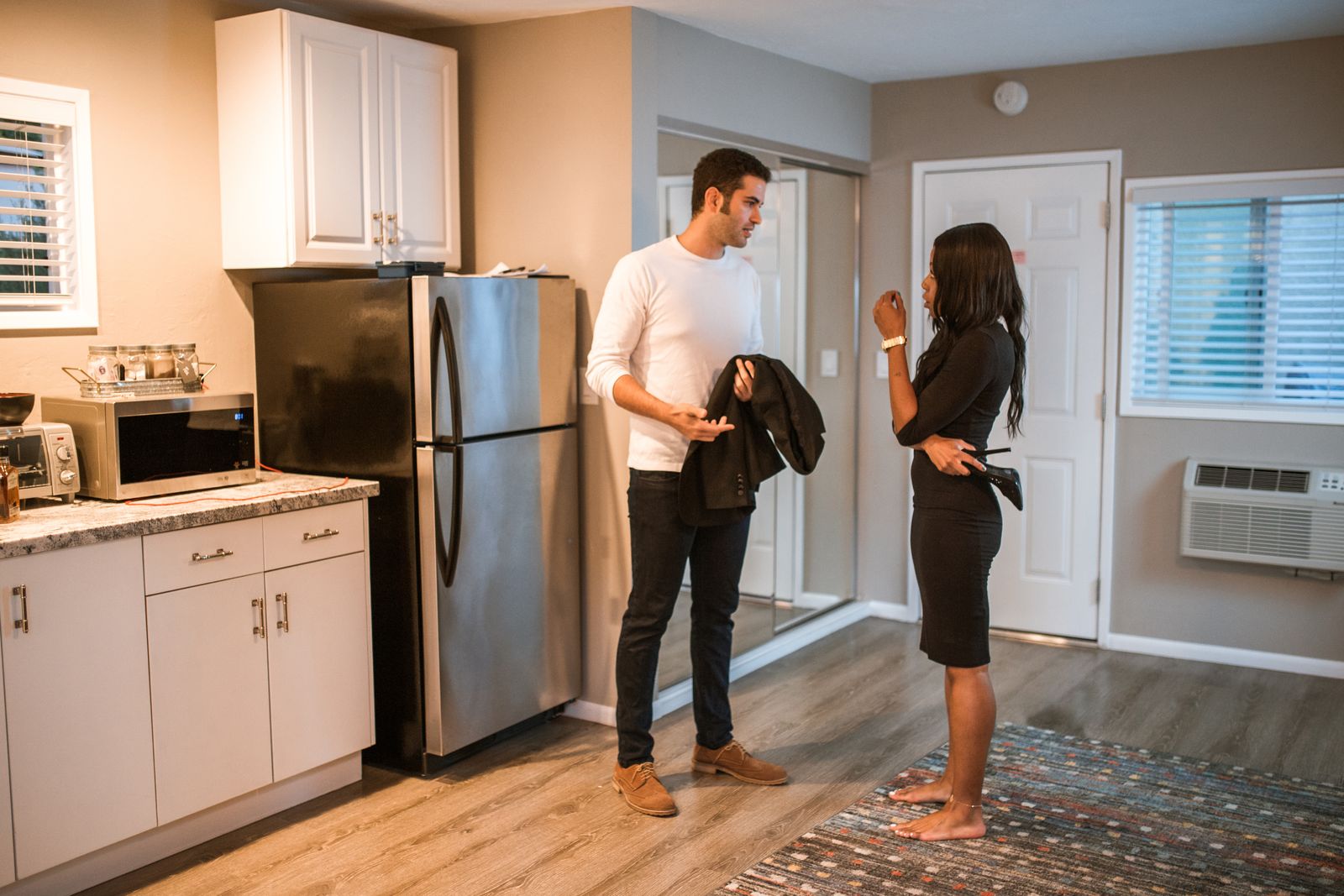 Two people talking in a kitchen