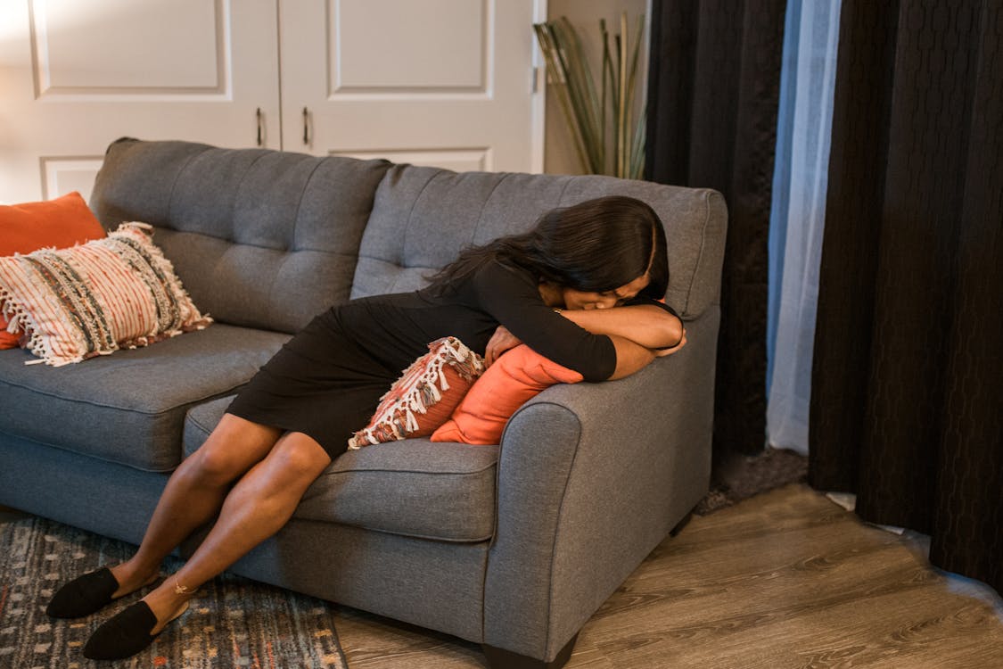 Woman in Black Clothes Lying Down on Couch Free Stock Photo