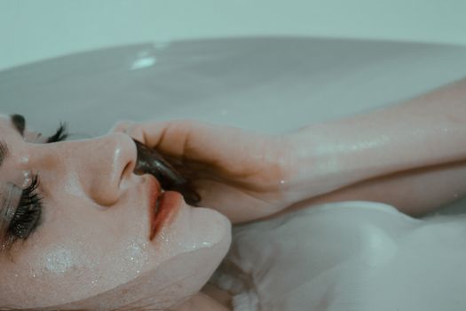 Sad woman with leaking mascara resting in bathtub