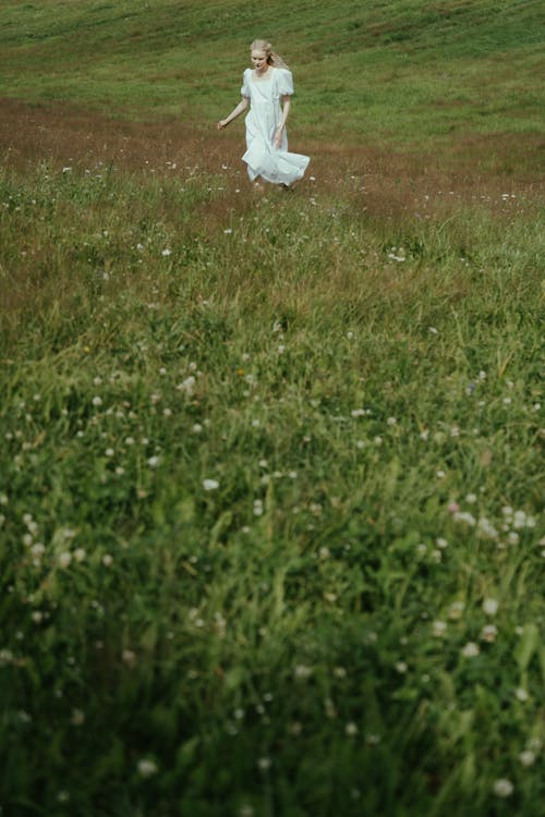 Blonde Woman in White Dress on Meadow