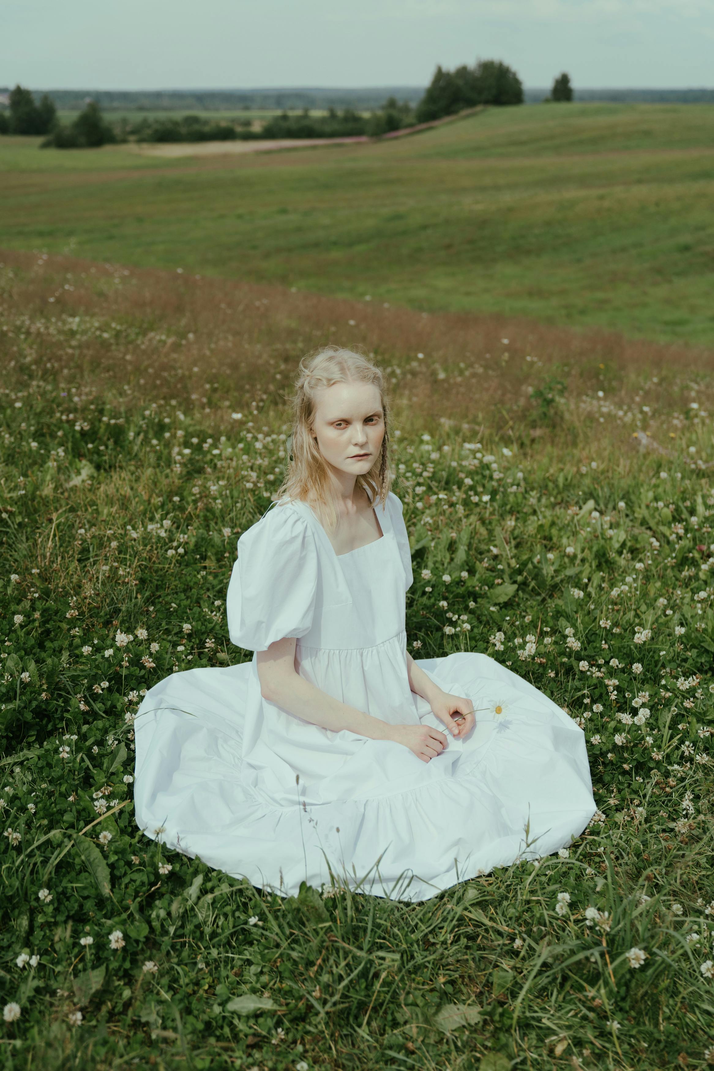 Girl in White Dress Sitting on Green Grass Field · Free Stock Photo