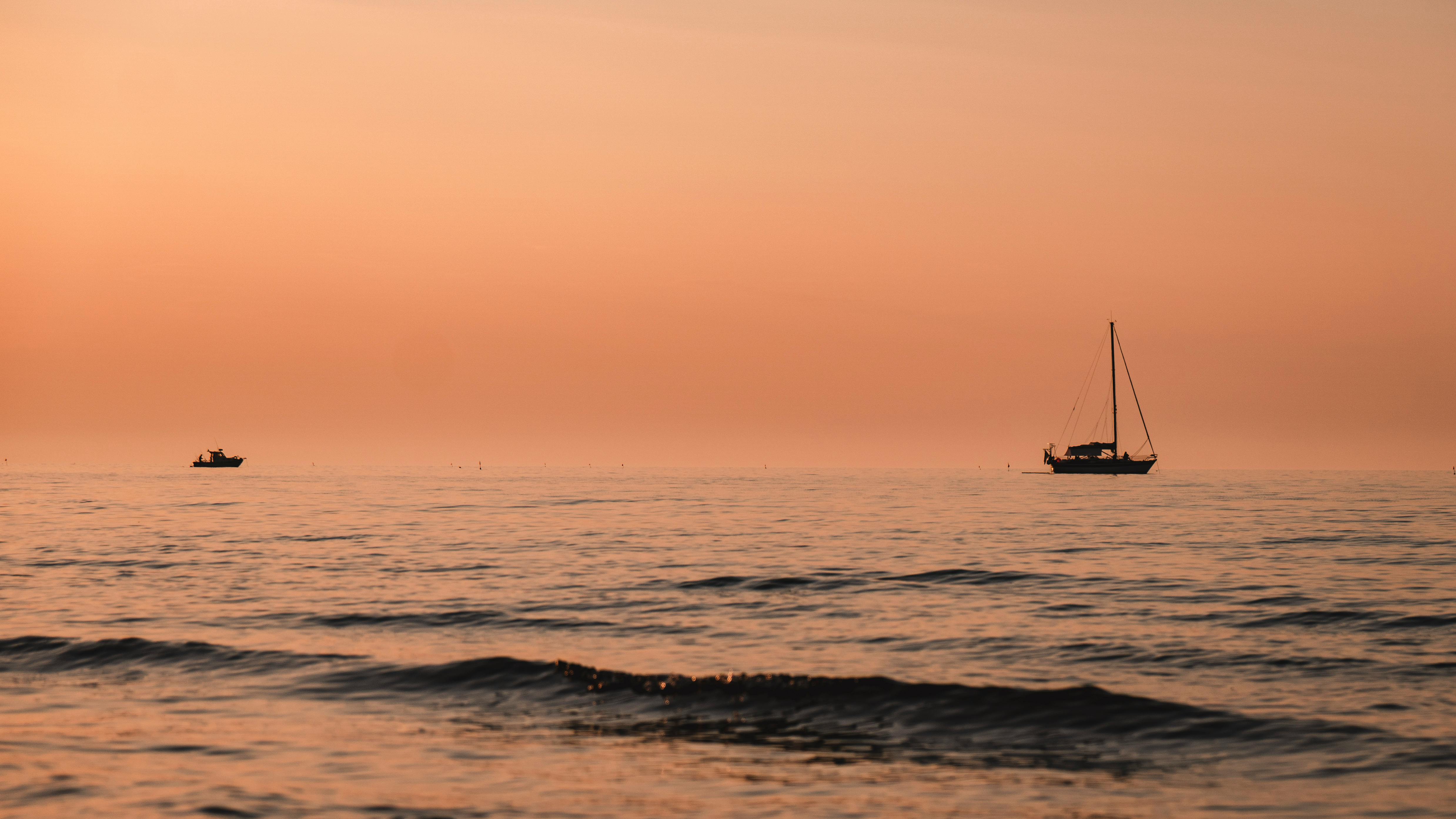 Peaceful scene of sailboats at sunset on the Adriatic Sea near Vasto, Italy.