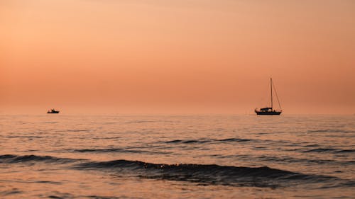 Free Silhouette of Boats on Sea during Sunset Stock Photo