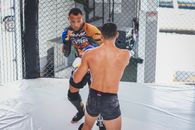 Man in Black Shorts and White and Black Shorts Sitting on White Floor