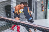 Man in Blue and Yellow Jersey Shirt and Black Shorts Sitting on Gray Metal Fence