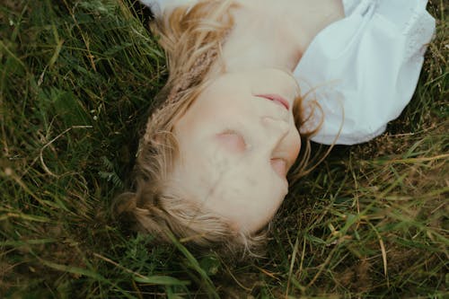 Close-up of Woman Lying Down on Grass 