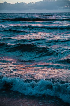 Sunset waves crash on a Mezizdroje beach, capturing the serene beauty of the Baltic Sea.