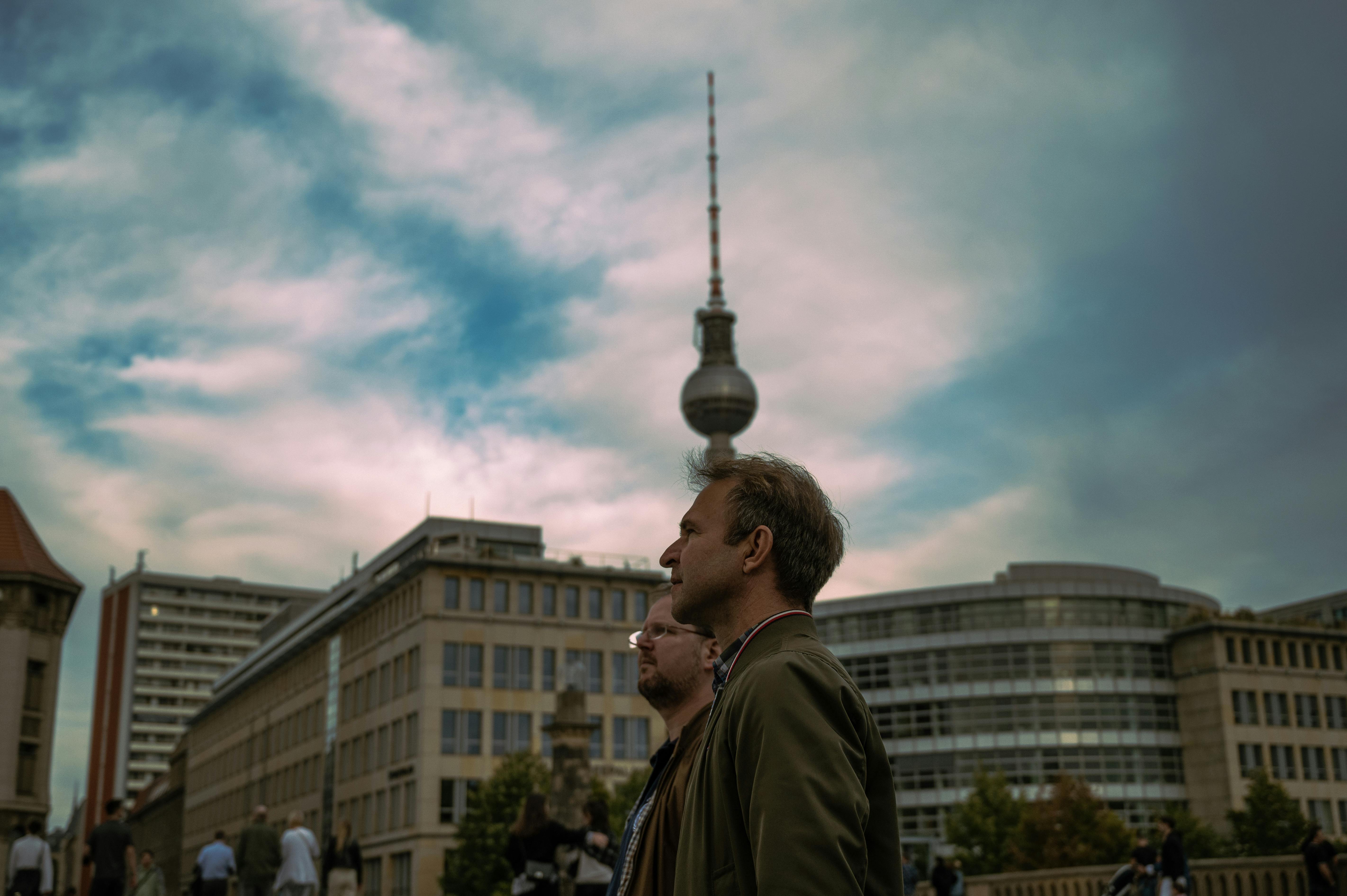 two men standing on a city street in berlin