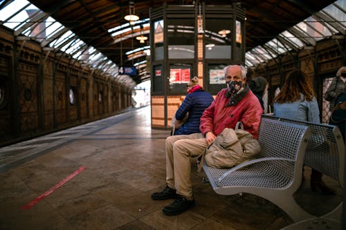 Commuter Sitting on Bench at Train Station