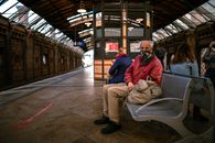 Man in Blue Jacket Sitting on Bench