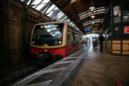 Free A sleek train arriving at a bustling Berlin station, capturing city life and travel Stock Photo