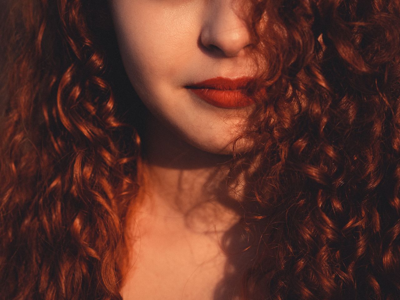 unrecognizable beautiful female with dark reddish fluffy hair and vivi