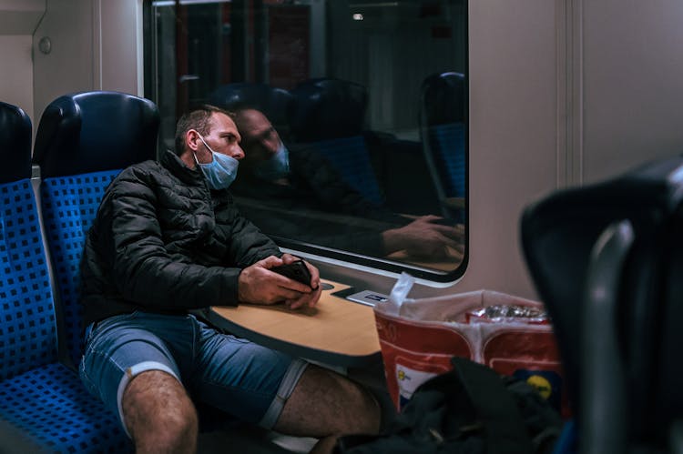 Man Travelling In Train At Night