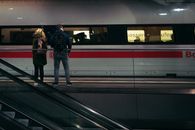 Man in Black Jacket Standing Beside Train
