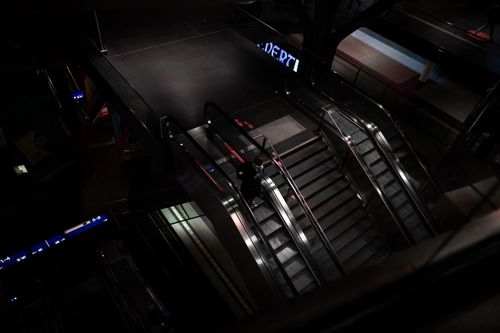 Free High angle view of escalators in a modern subway station at night, featuring urban architecture. Stock Photo