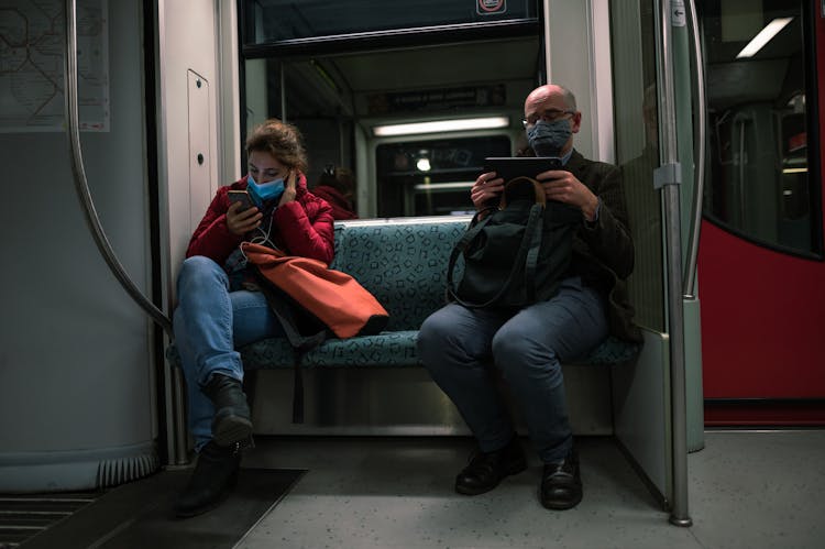 Man And Woman Sharing Subway Seat