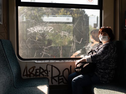 Woman in Train with Graffiti