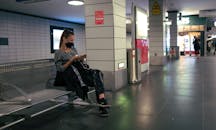 Man in Black Jacket Sitting on Black Chair