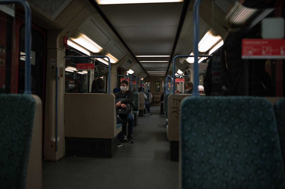 People Travelling on Train in Face Masks 