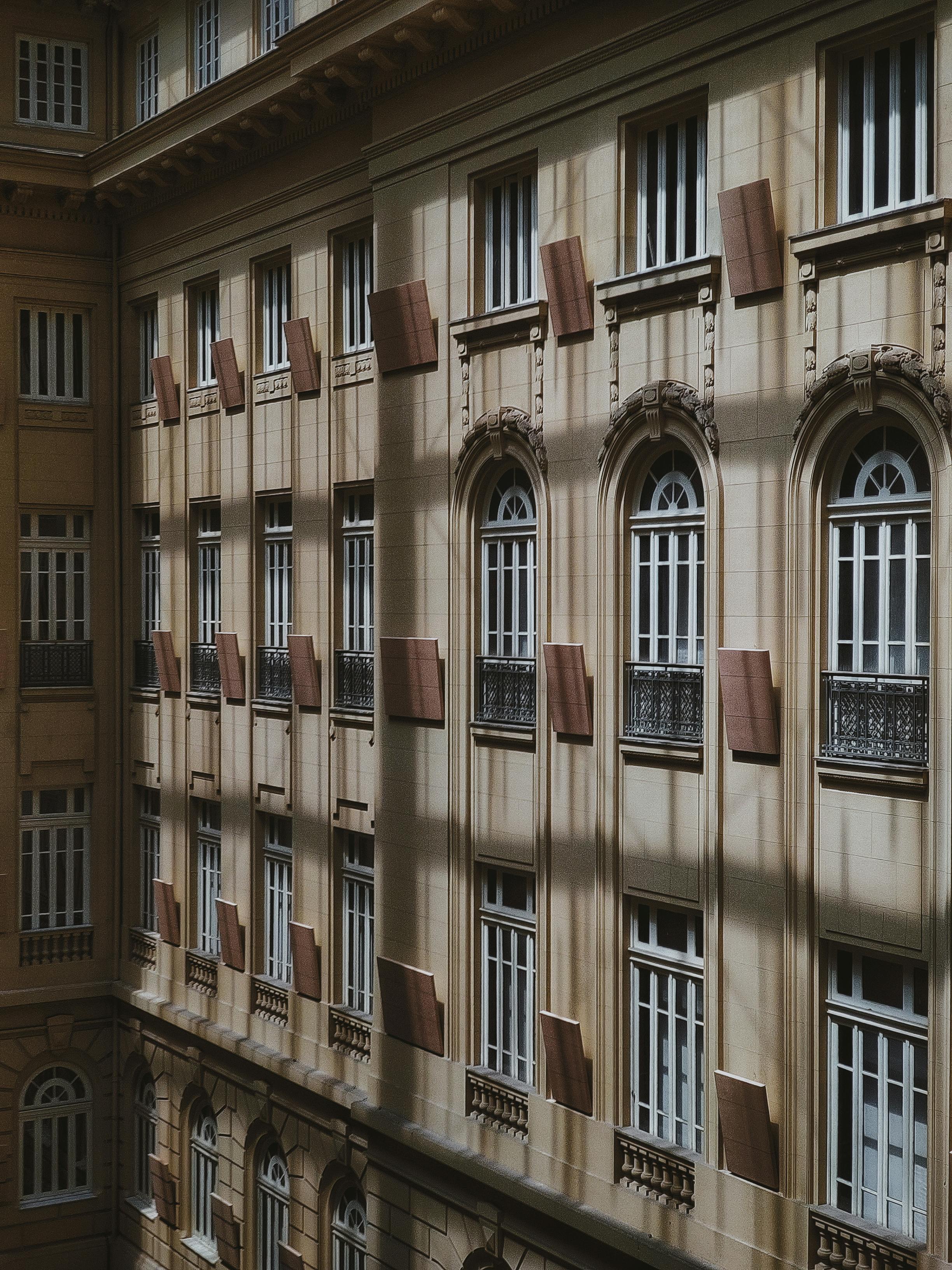 Elegant urban facade showcasing classic arched windows in MG, Brazil, under natural daylight.