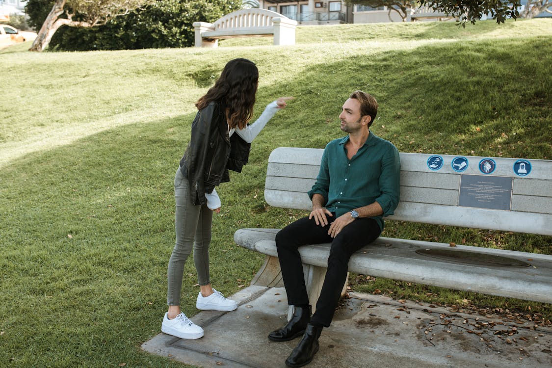 Free Woman in Black Jacket Pointing at a Man Stock Photo