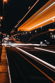 Captivating long exposure shot of vibrant city light trails on a bustling highway at night.