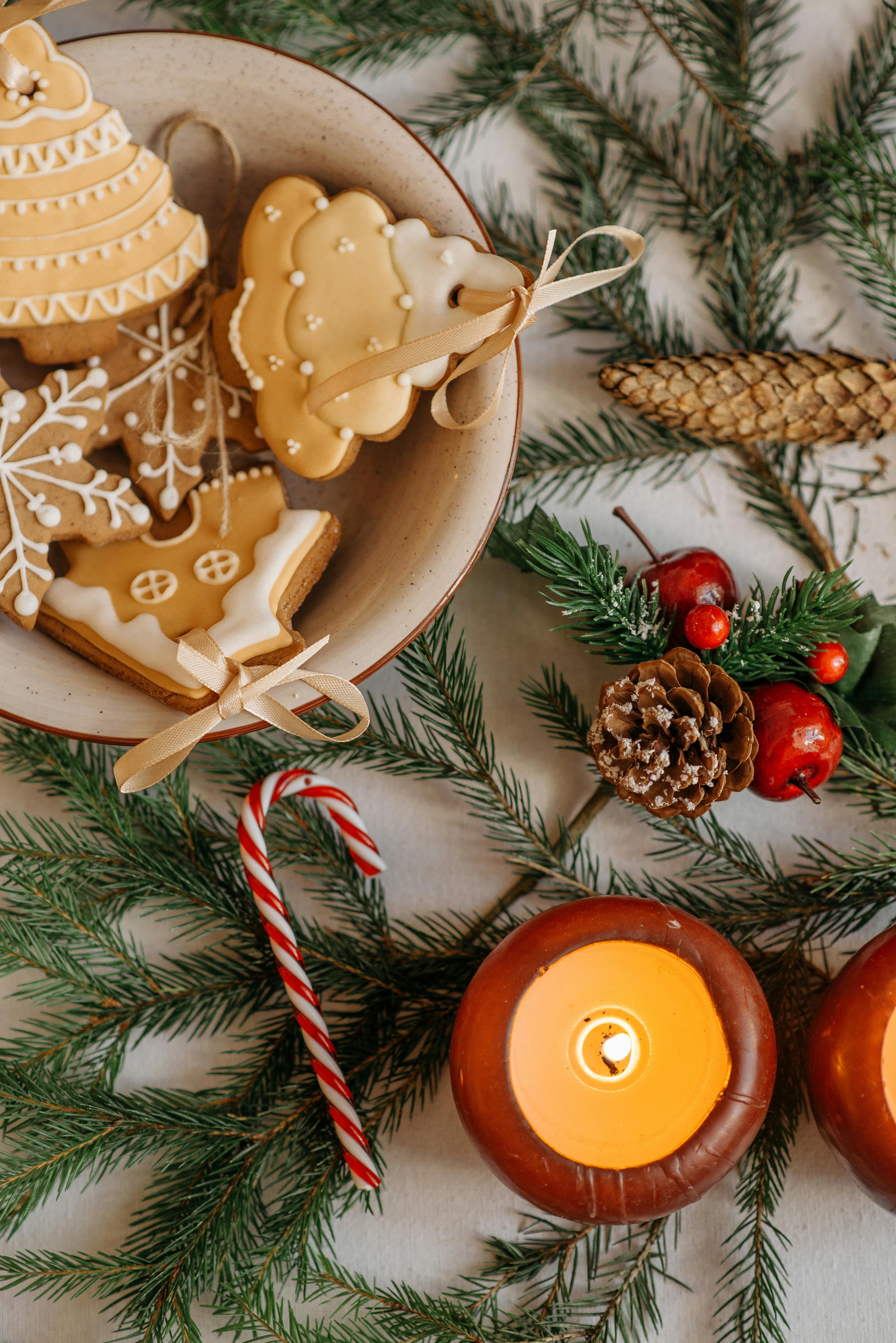 a top view of a bowl of gingerbread cookies and christmas decorations