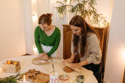 Women Flattening the Dough Together 
