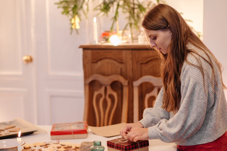 A Woman Opening A Gift