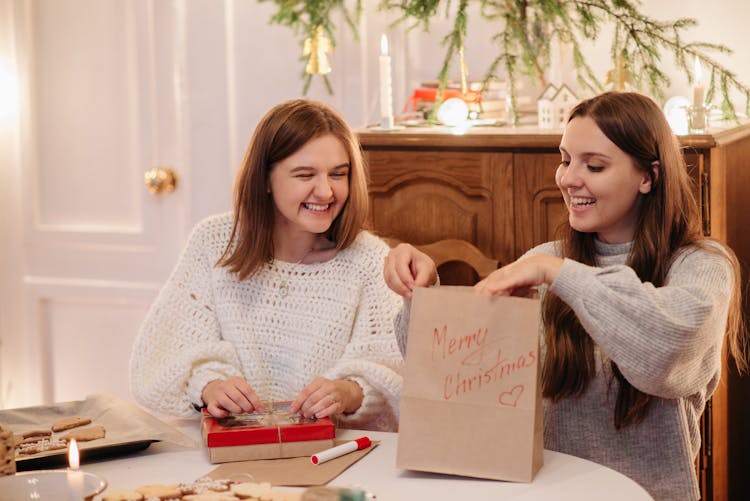 Women Opening Presents During Christmas