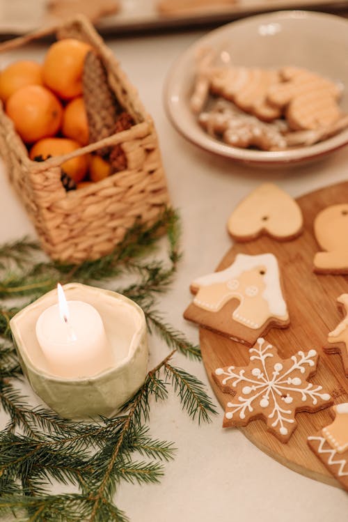 Free Burning Candle Beside Christmas Cookies Stock Photo