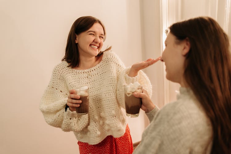 Women Holding Chocolate Drinks