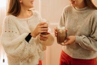 两位女士在室内享用热巧克力，共享温馨时光