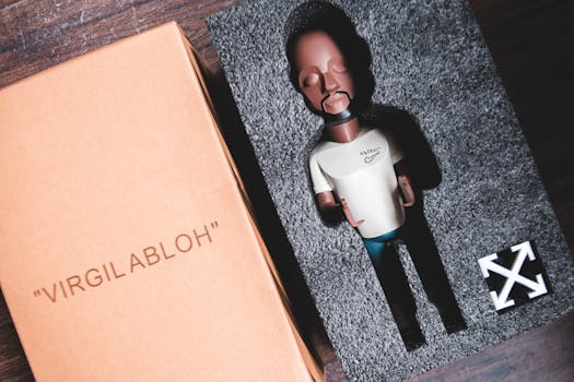 Designer figurine in boxed packaging showcasing Virgil Abloh's brand style.
