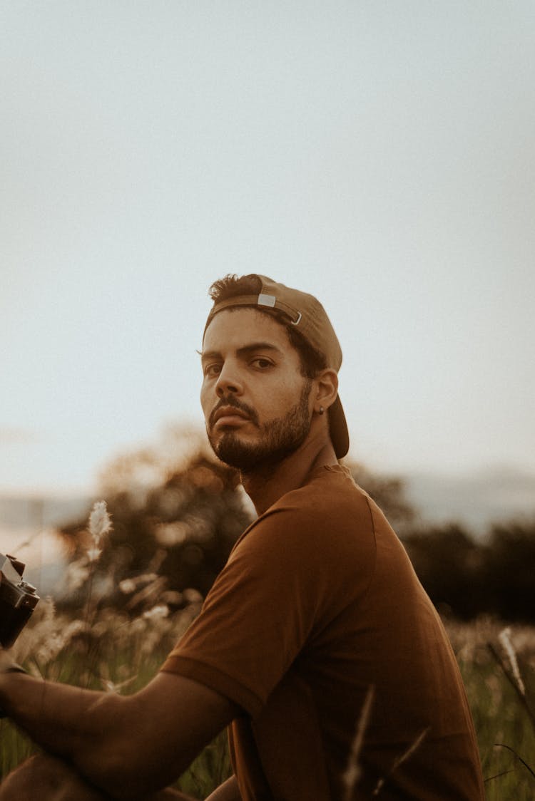 Man In Brown T Shirt Looking Sideways