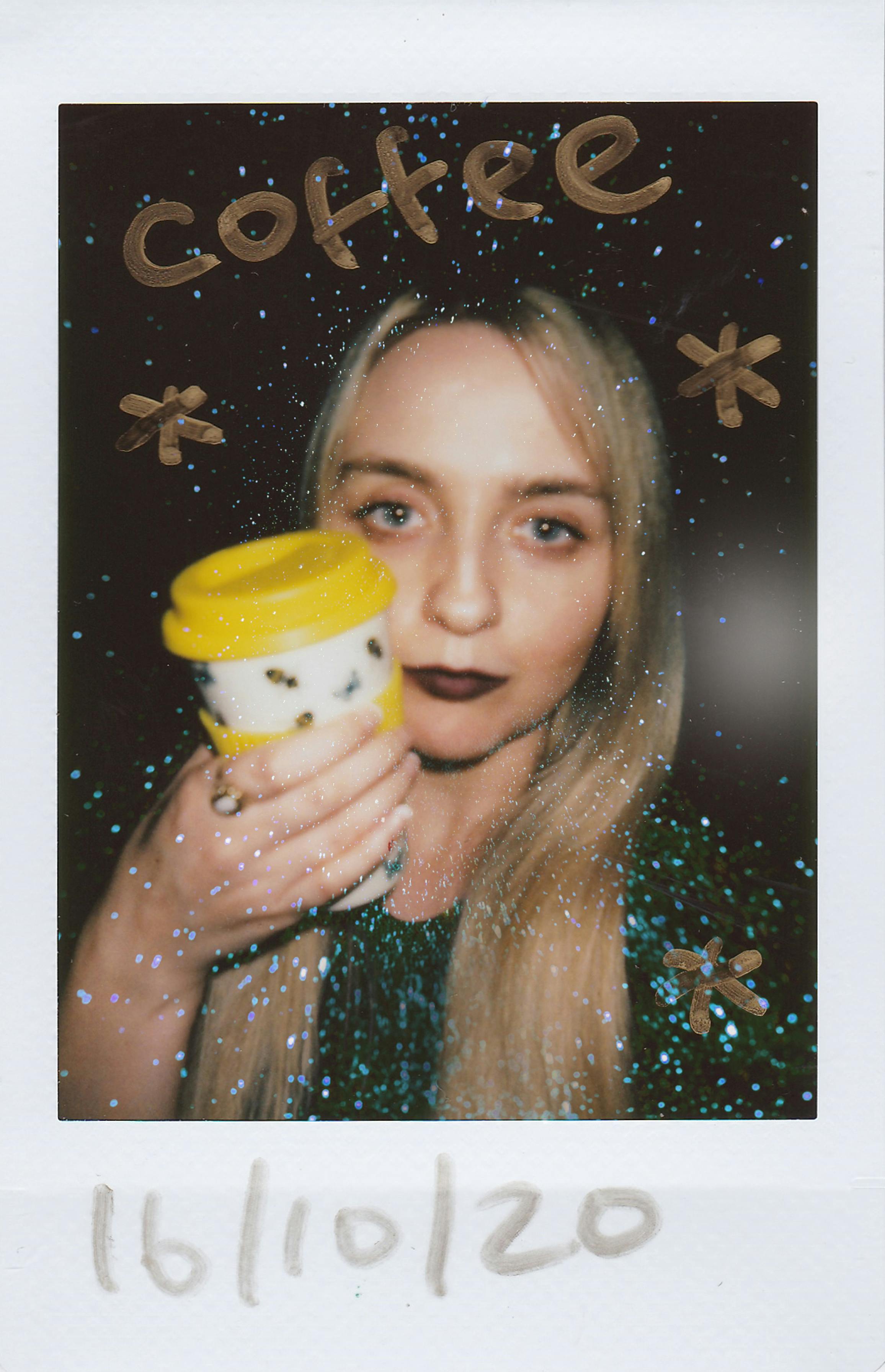 A creative portrait of a woman holding a coffee cup, accented with sparkles.