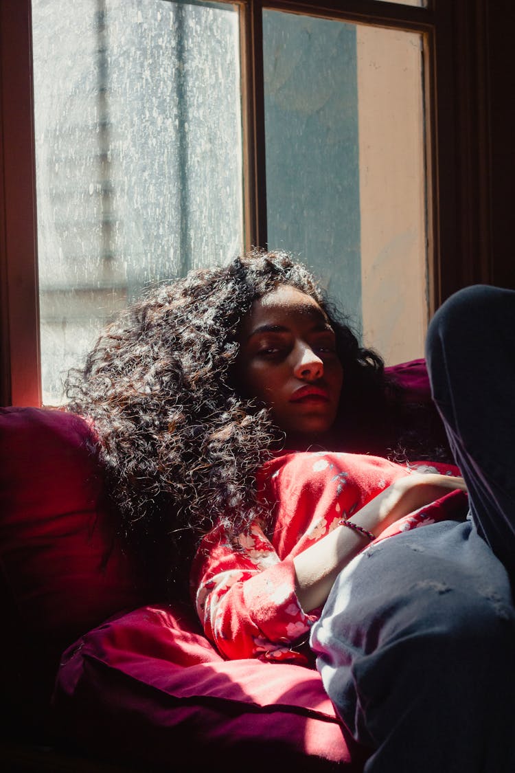 Calm Young Ethnic Lady Relaxing On Sofa At Home