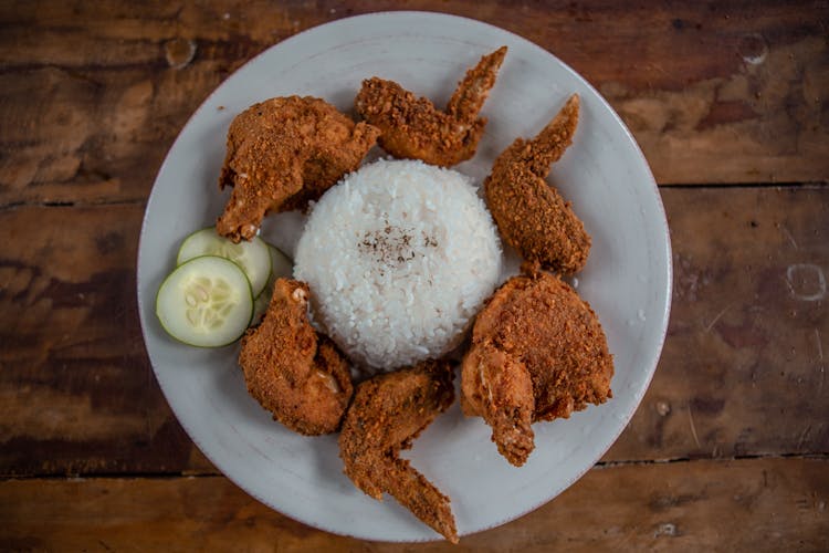 Delicious Fried Chicken Wings And Rice On Plate