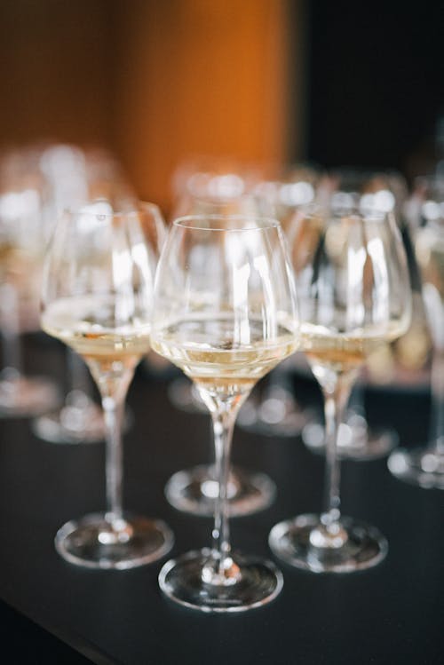 Clear Champagne Glasses on Black Table