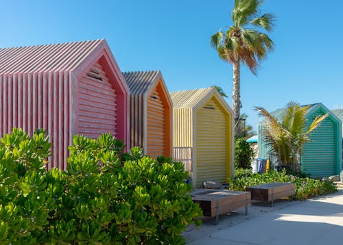 Colorful Beach Huts Near Green Trees Under Blue Sky