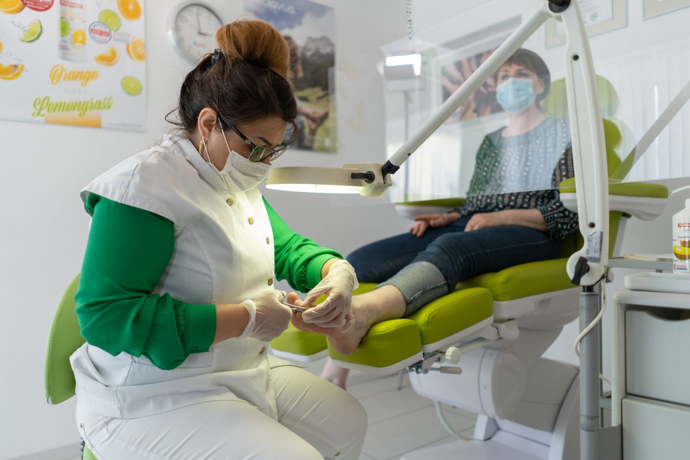 Professional pedicure service performed in a modern salon with protective hygiene practices