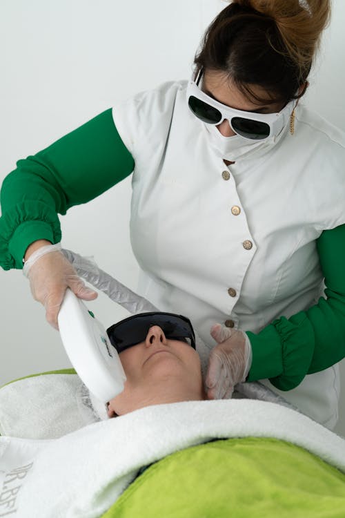 professional cosmetician doing face skin care procedure 