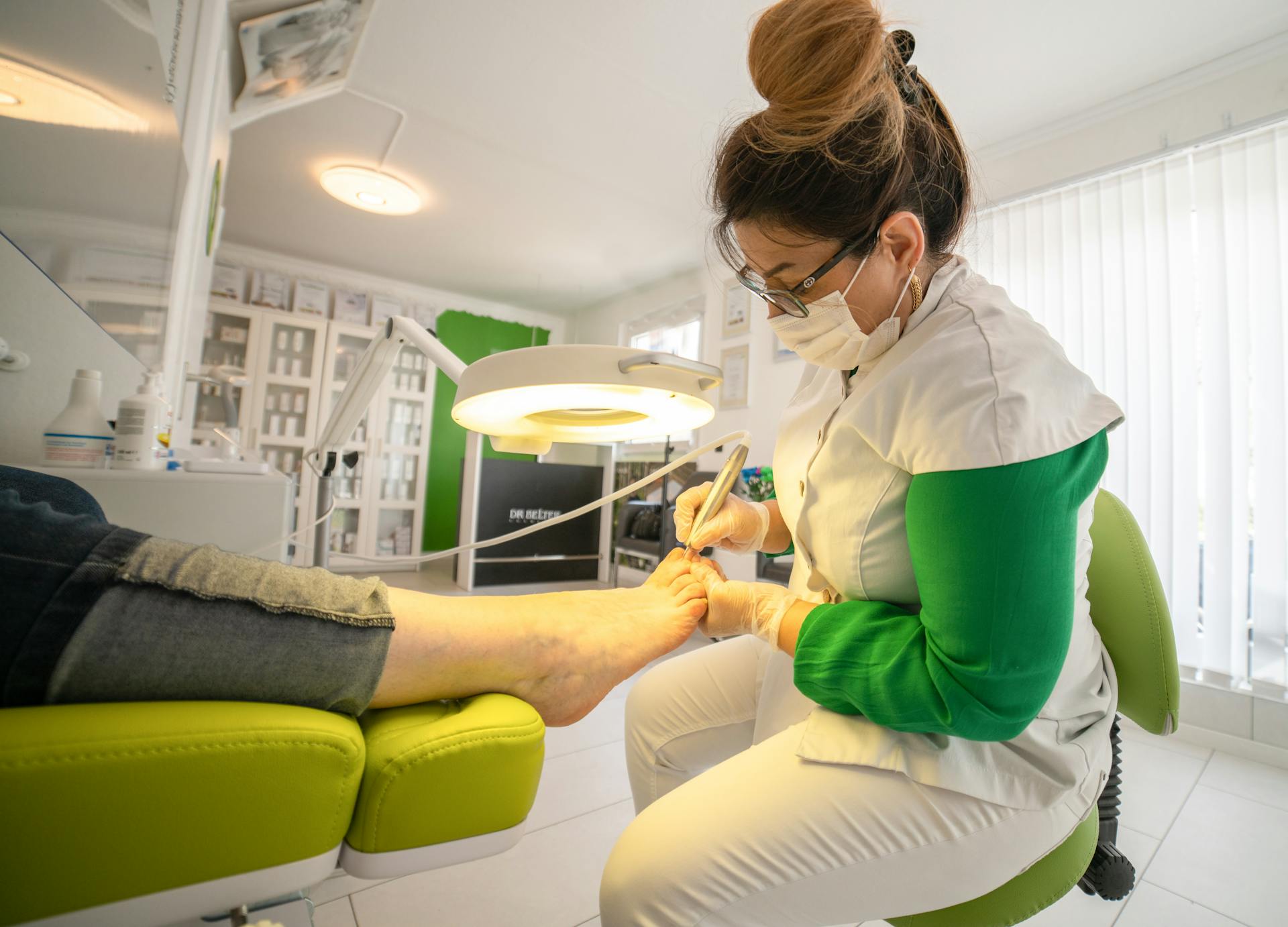 Focused woman doing procedure on foot of client