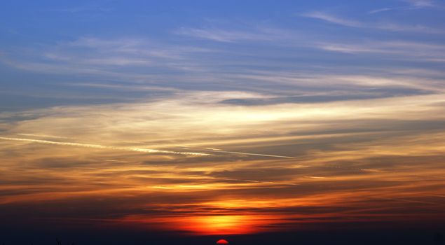 A stunning sunset with vibrant colors and dramatic cloud formations in the sky.